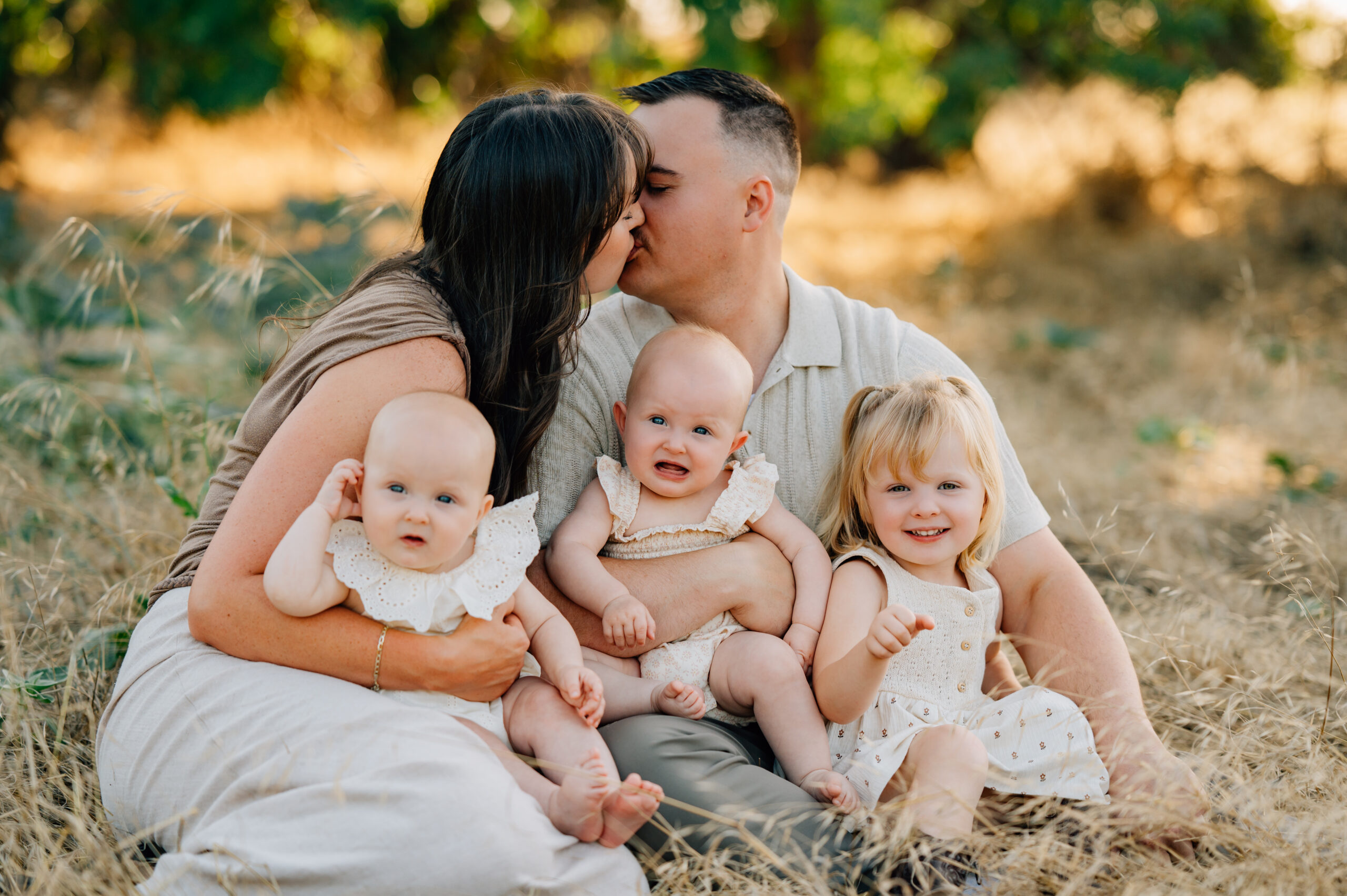 Family of five posing together during a golden hour family photography session at Oak Grove Park in Ripon, California.