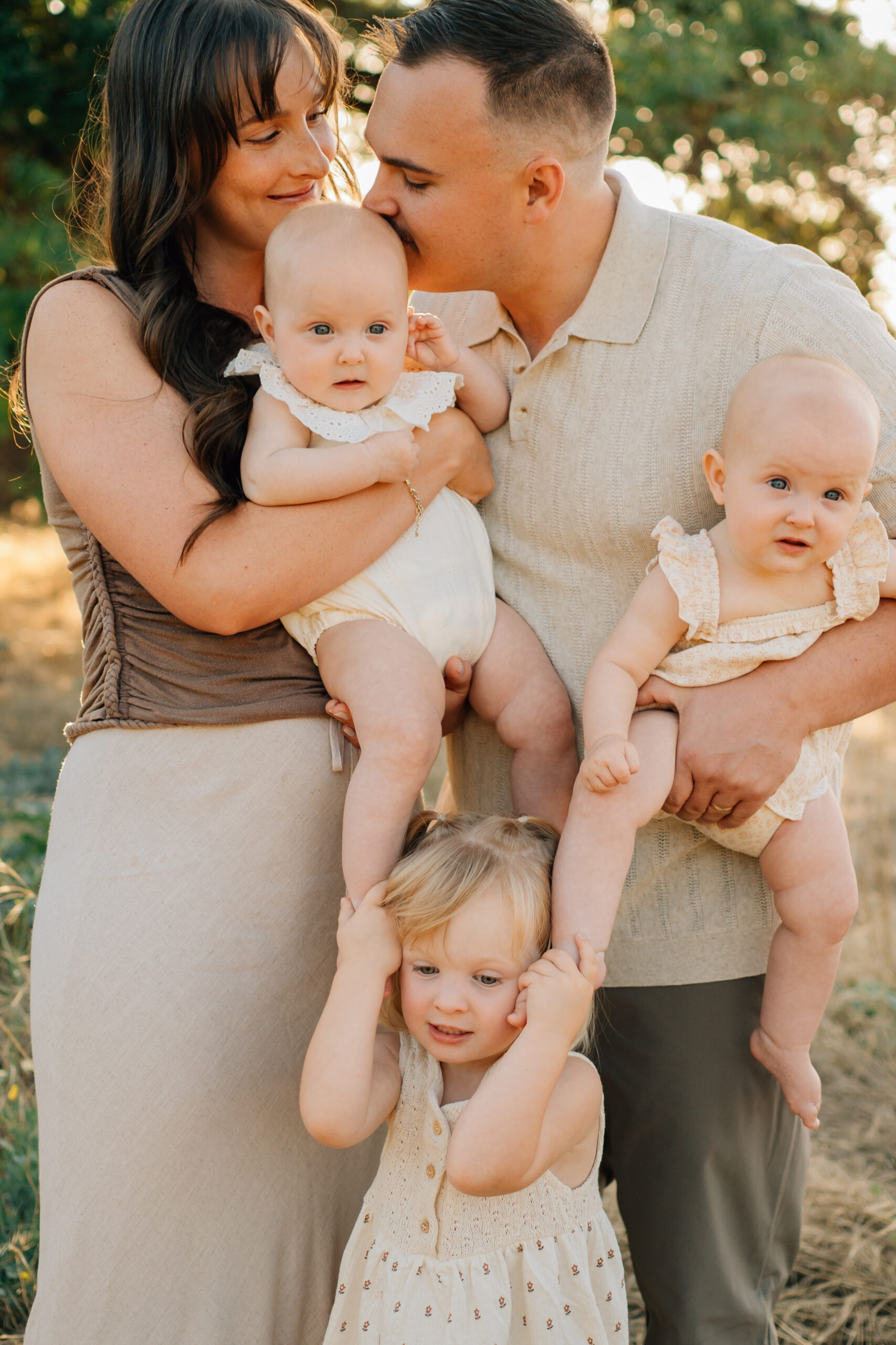 Family of five posing together during a golden hour family photography session at Oak Grove Park in Ripon, California.