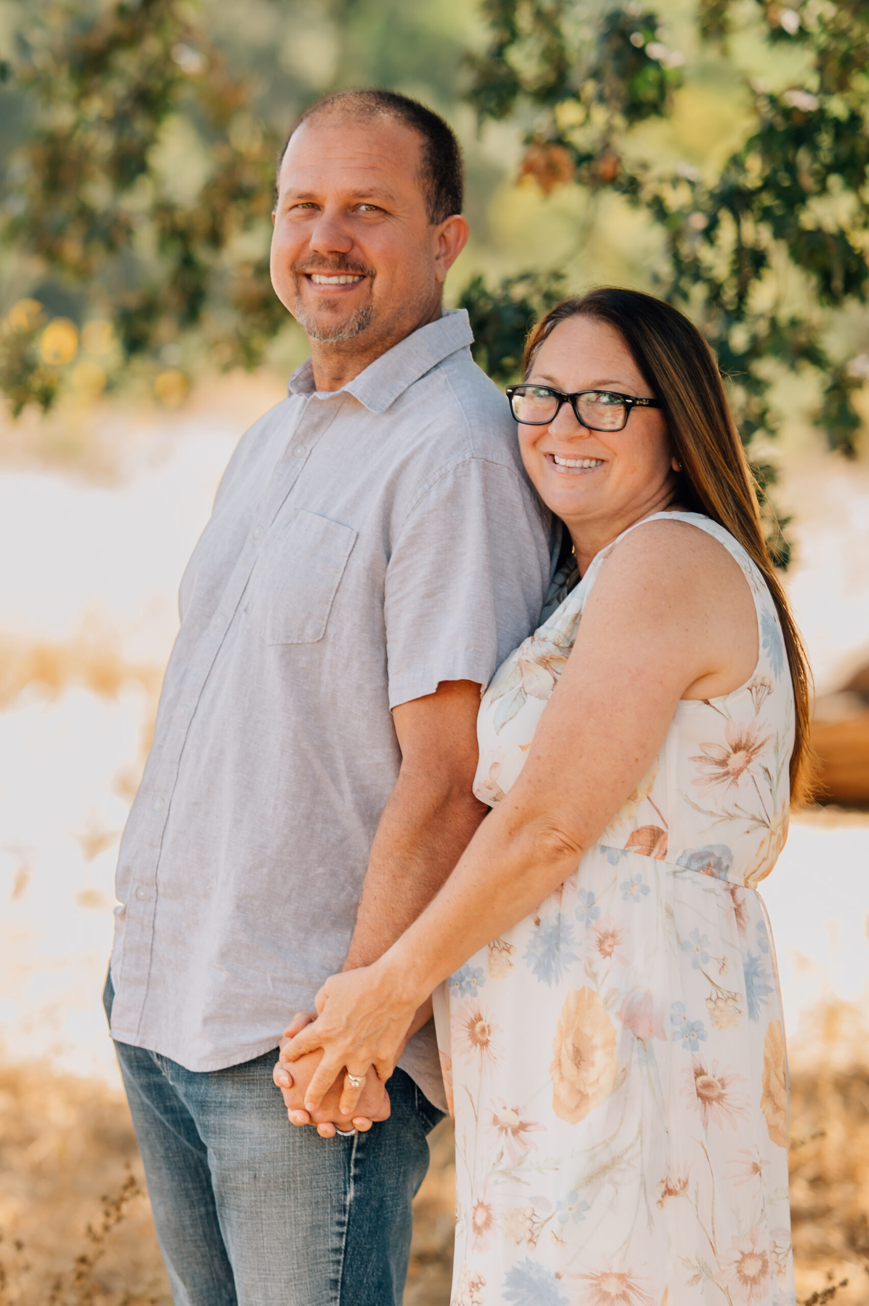Hand in hand this couple poses under a giant oak tree in Ripon, CA.