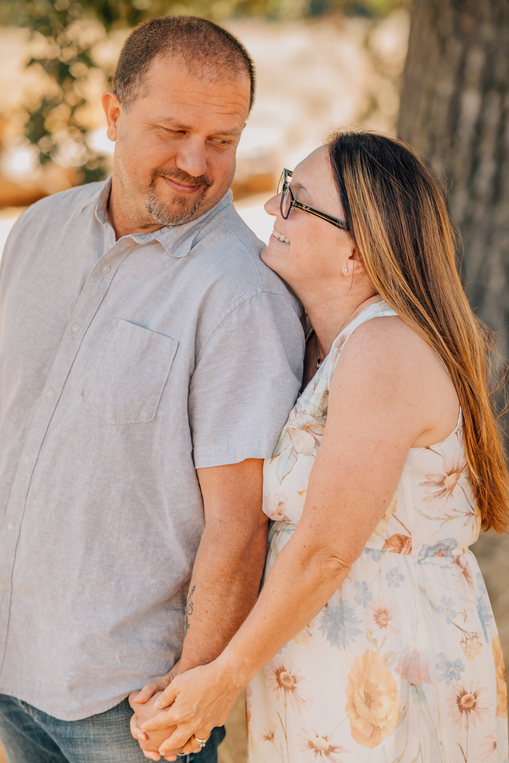 A couple looking into each others eyes at an extended family session. 