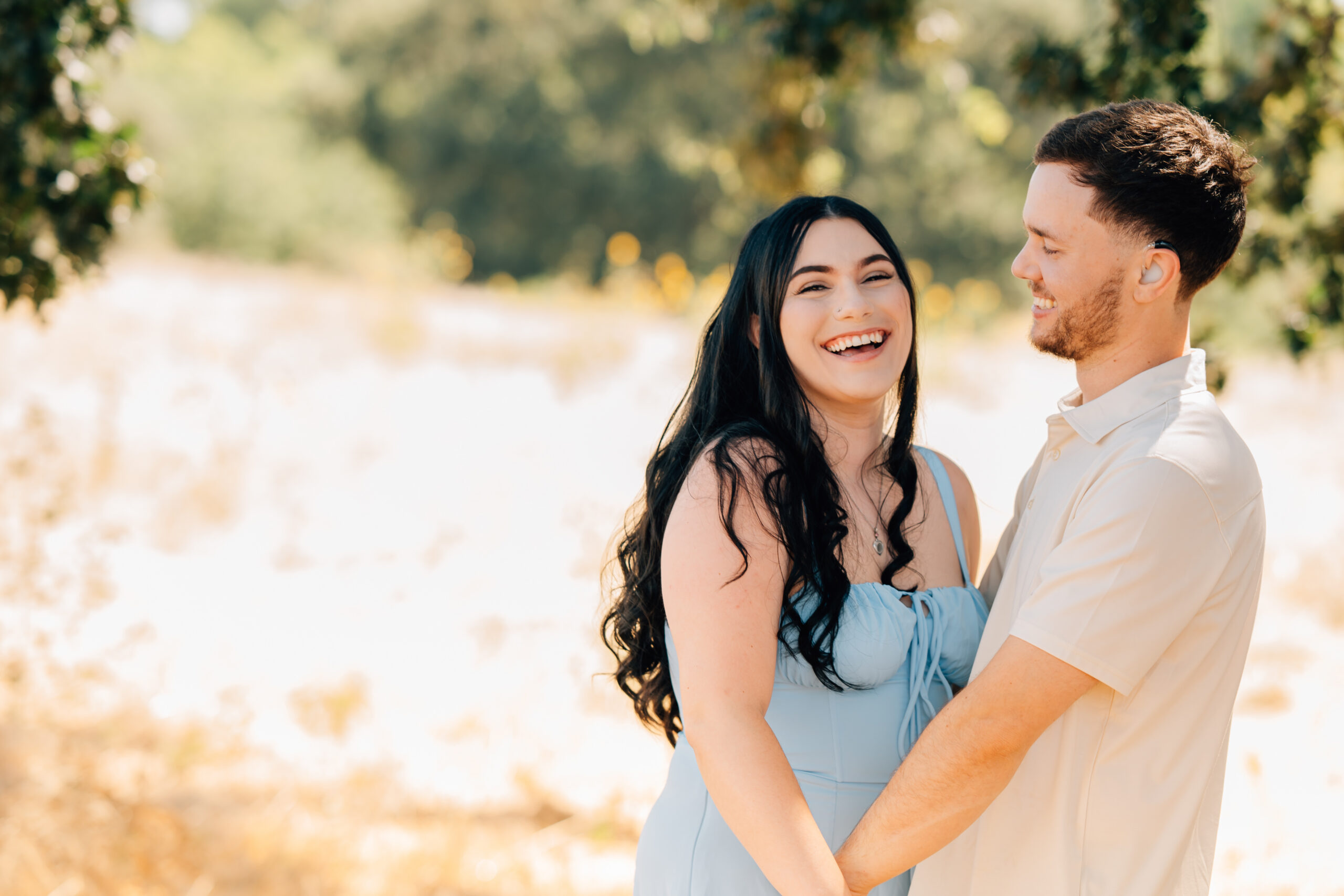 A couple laughing during an extended family session.
